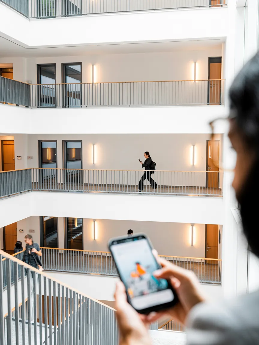 AI-generated image: Modern Swiss residential building, stairwell with wall sconces — LED Lichtkompetenz